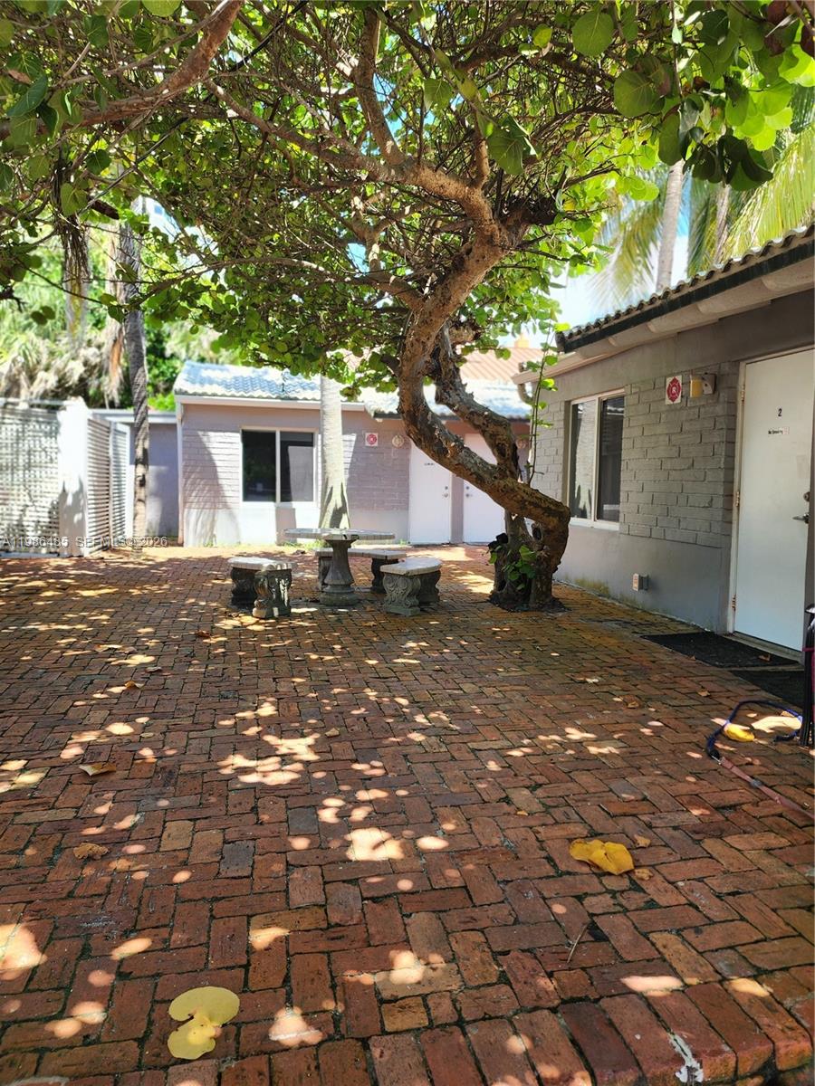 315 Walnut Street, Unit 2 Hollywood, FL 33019 - Photo 20 of 23 a backyard of a house with yard and outdoor seating