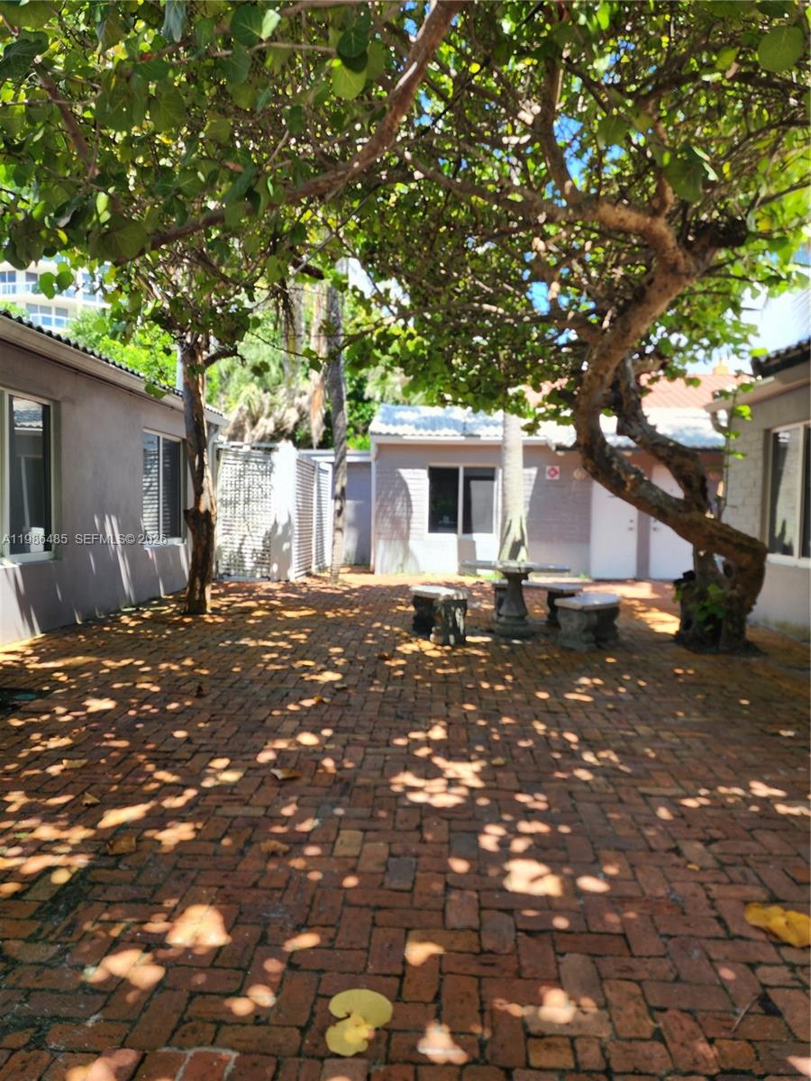 315 Walnut Street, Unit 2 Hollywood, FL 33019 - Photo 21 of 23 a front view of a house with a tree