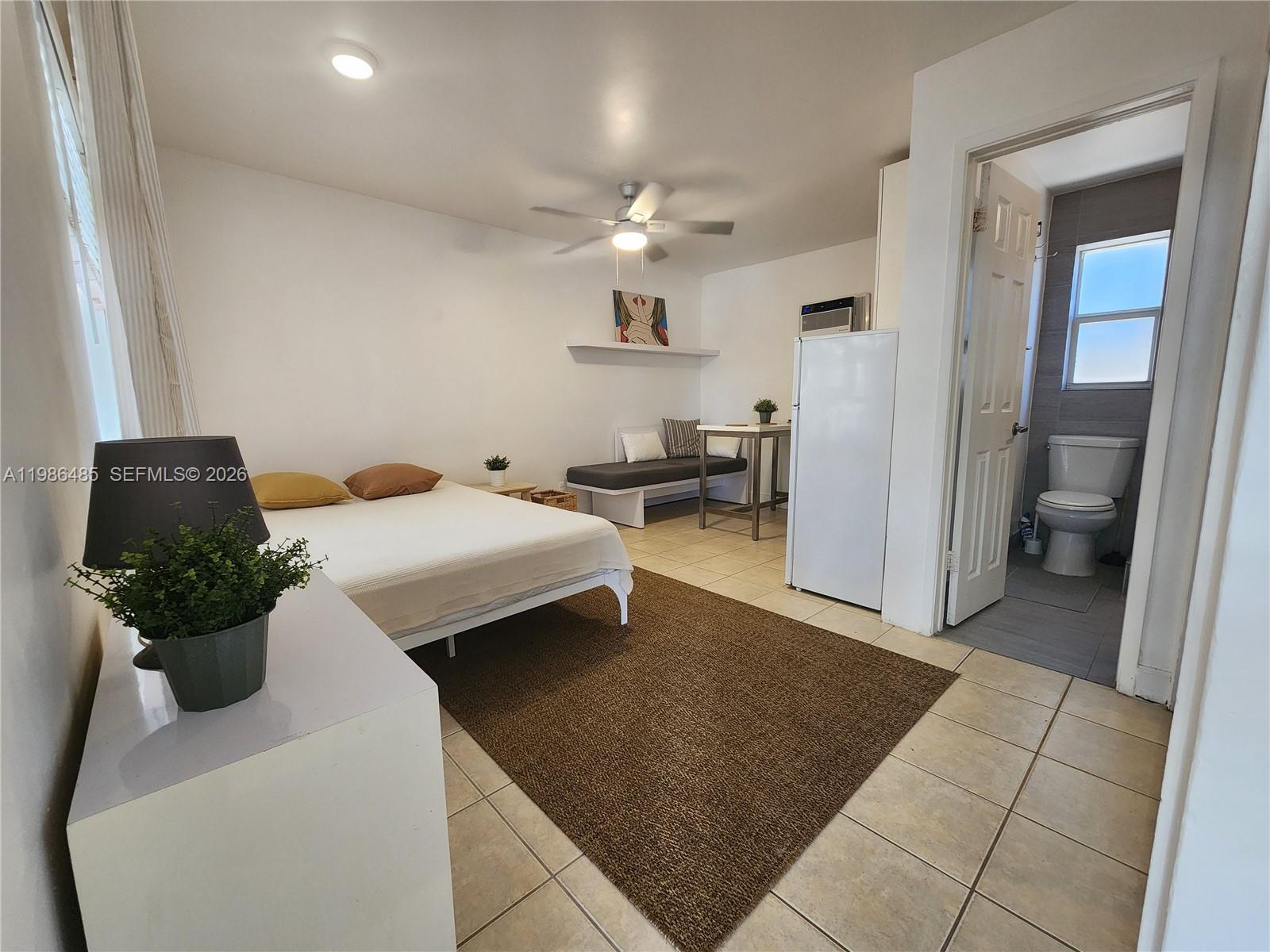 315 Walnut Street, Unit 2 Hollywood, FL 33019 - Photo 6 of 23 a living room with furniture and a chandelier