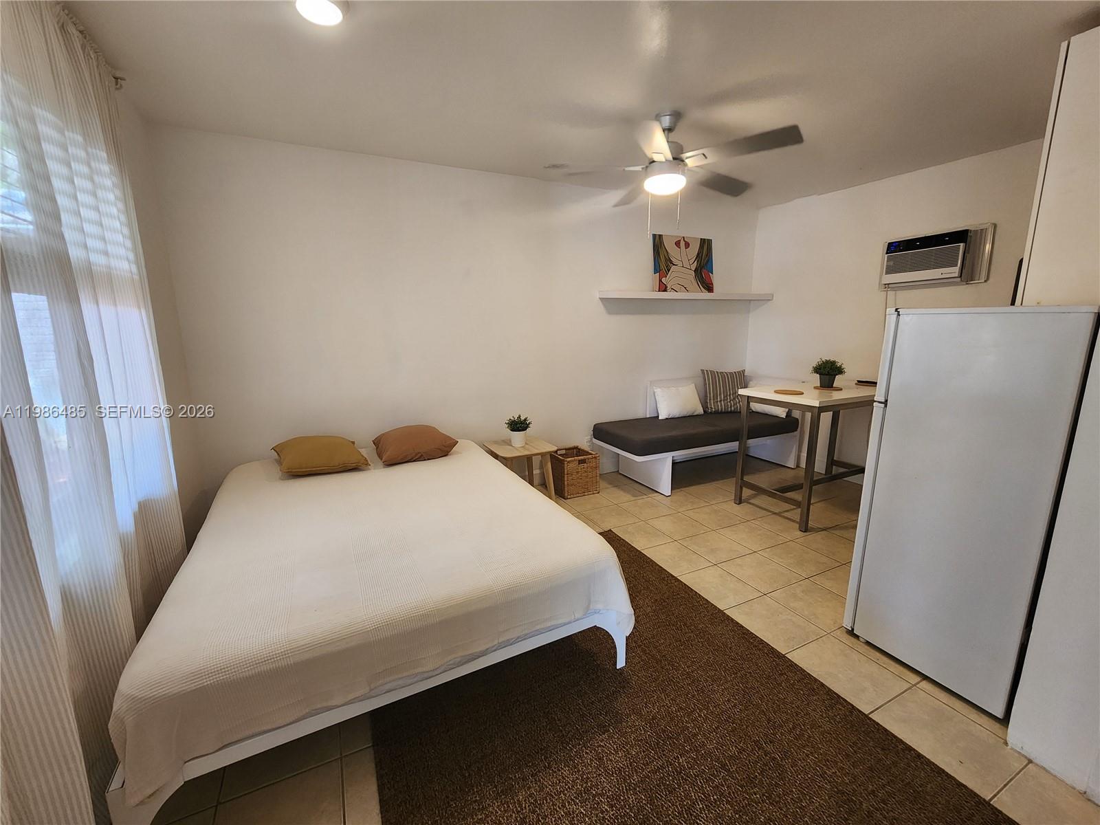 315 Walnut Street, Unit 2 Hollywood, FL 33019 - Photo 7 of 23 a bedroom with a bed and a refrigerator