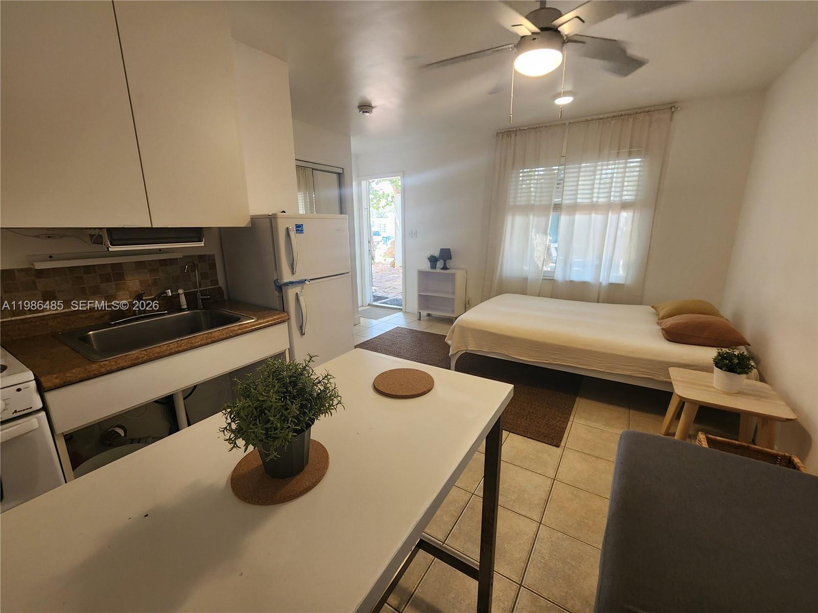315 Walnut Street, Unit 2 Hollywood, FL 33019 - Photo 10 of 23 a bedroom with furniture and a window