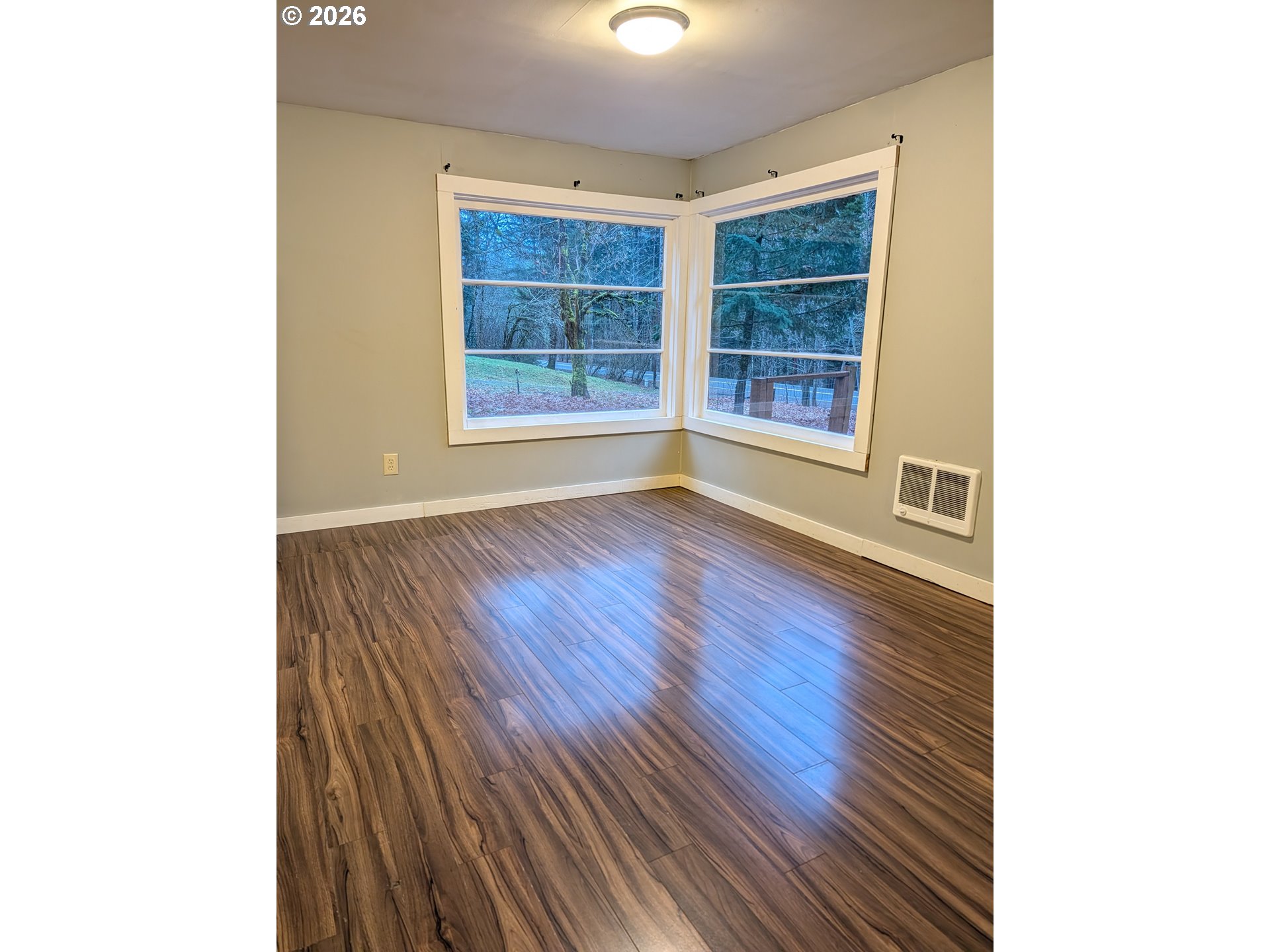 8892 Wind River Highway Carson, WA 98610 - Photo 6 of 7 a view of an empty room with wooden floor and a window