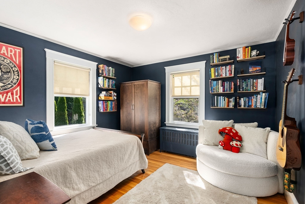 241 Weston Road Wellesley, MA 02482 - Photo 15 of 27 a bedroom with a bed and a book shelf