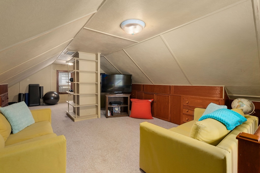 241 Weston Road Wellesley, MA 02482 - Photo 19 of 27 a living room with furniture and a flat screen tv