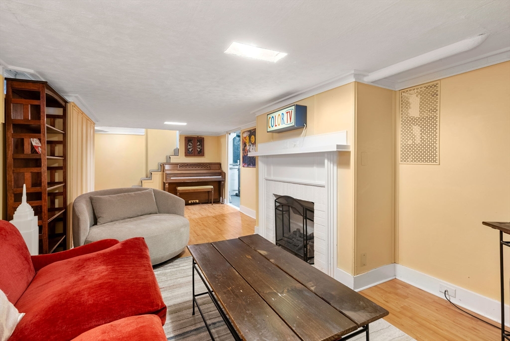241 Weston Road Wellesley, MA 02482 - Photo 21 of 27 a living room with furniture and a fireplace