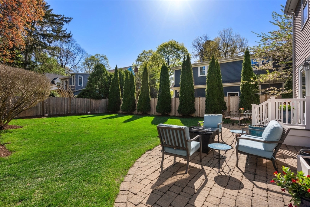 241 Weston Road Wellesley, MA 02482 - Photo 22 of 27 a view of a chairs and table in backyard of the house