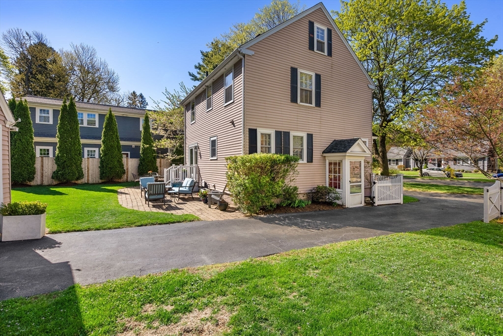 241 Weston Road Wellesley, MA 02482 - Photo 23 of 27 a front view of a house with a yard and green space