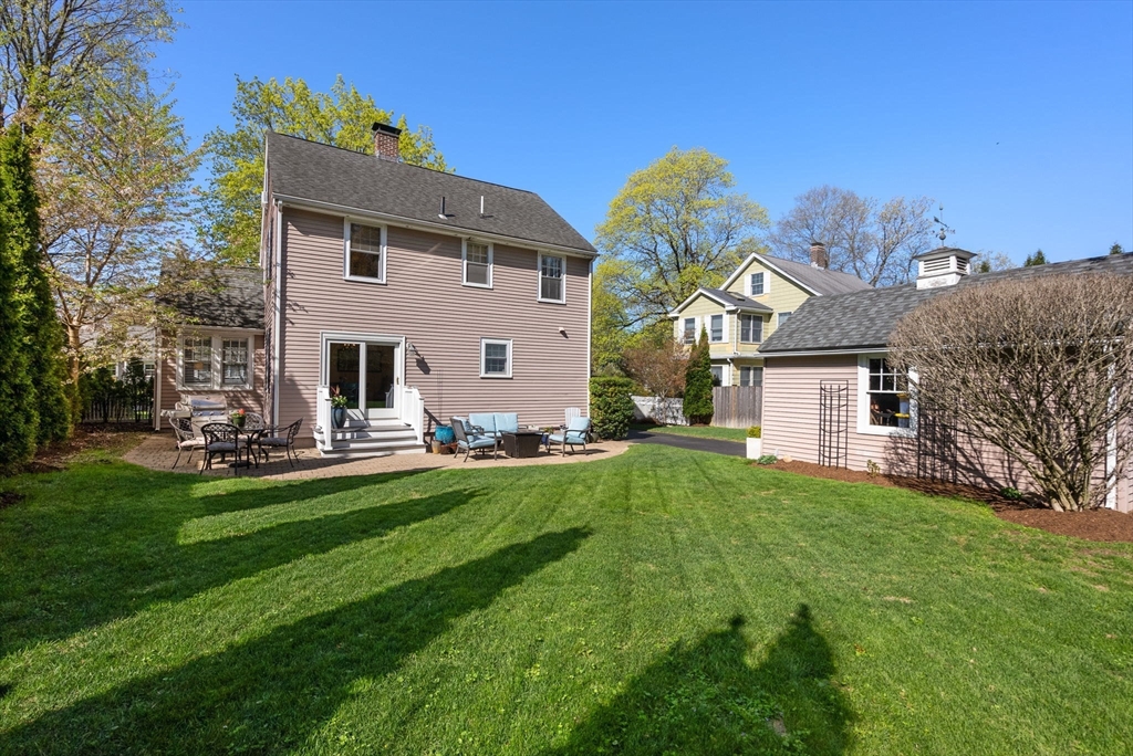 241 Weston Road Wellesley, MA 02482 - Photo 26 of 27 a front view of a house with a garden and plants