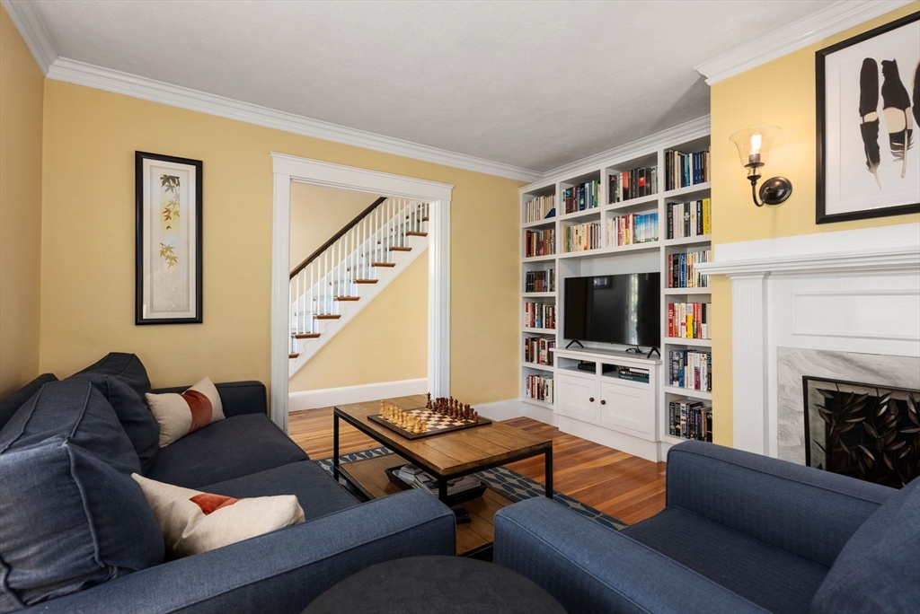 241 Weston Road Wellesley, MA 02482 - Photo 5 of 27 a living room with furniture a flat screen tv and a fireplace