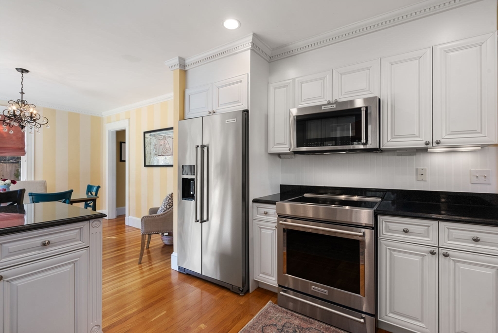 241 Weston Road Wellesley, MA 02482 - Photo 8 of 27 a kitchen with granite countertop a stove microwave and refrigerator