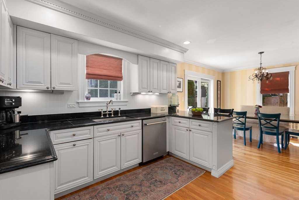 241 Weston Road Wellesley, MA 02482 - Photo 10 of 27 a kitchen with granite countertop a sink cabinets and wooden floor