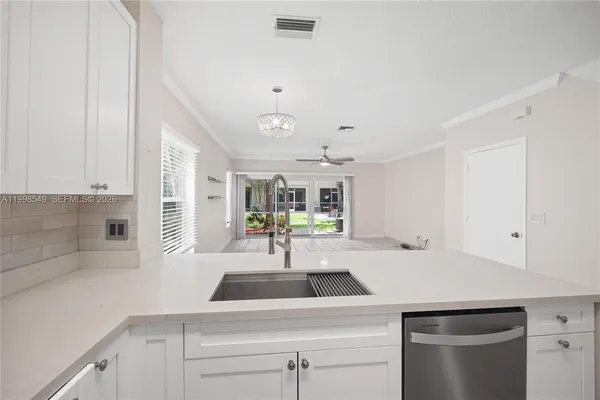 a kitchen with a sink and a refrigerator