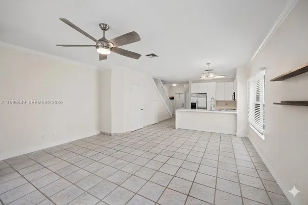 a view of a kitchen with white cabinets and white appliances