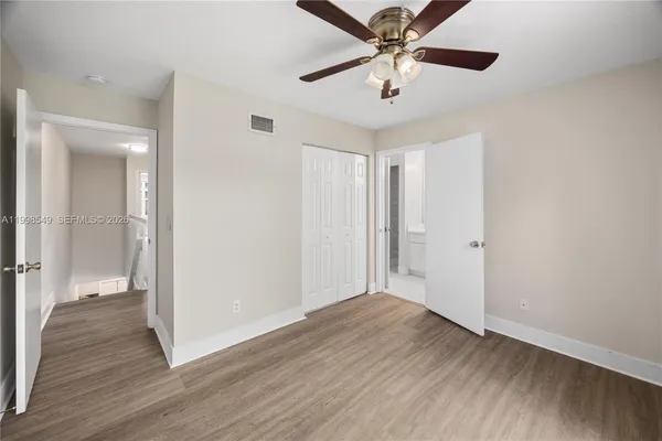 a view of an empty room and wooden floor