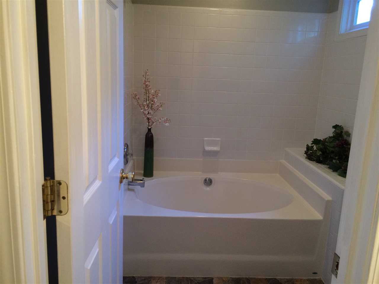 515 Windcrest Road Durham, NC 27713 - Photo 13 of 15 Sunlight streams through the transom window as you relax in the garden tub.