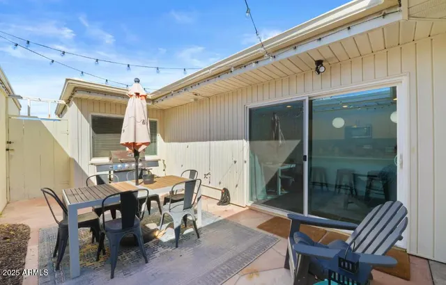 a view of an outdoor dining space with a table and chairs