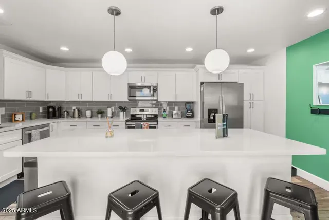 a kitchen with cabinets a sink and appliances