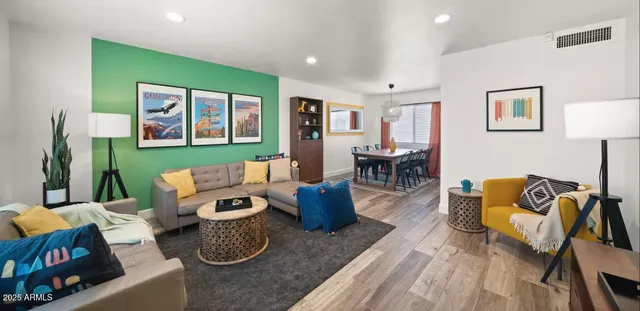 a living room with furniture and wooden floor