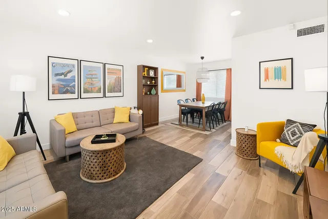 a living room with furniture and wooden floor