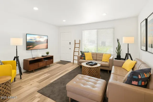 a living room with furniture and a flat screen tv