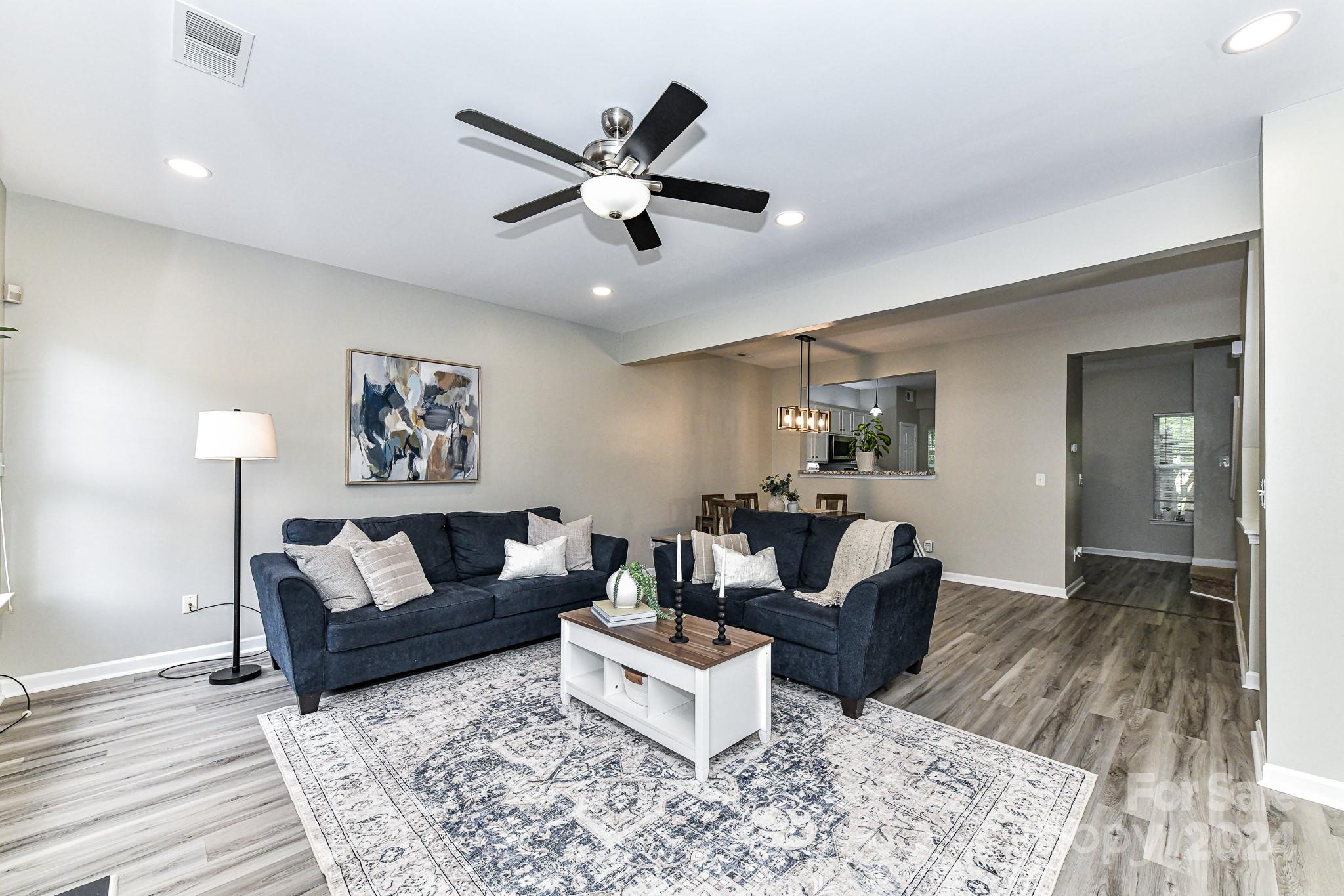 9665 Bailey Road Cornelius, NC 28031 - Photo 12 of 31 a living room with furniture and a wooden floor