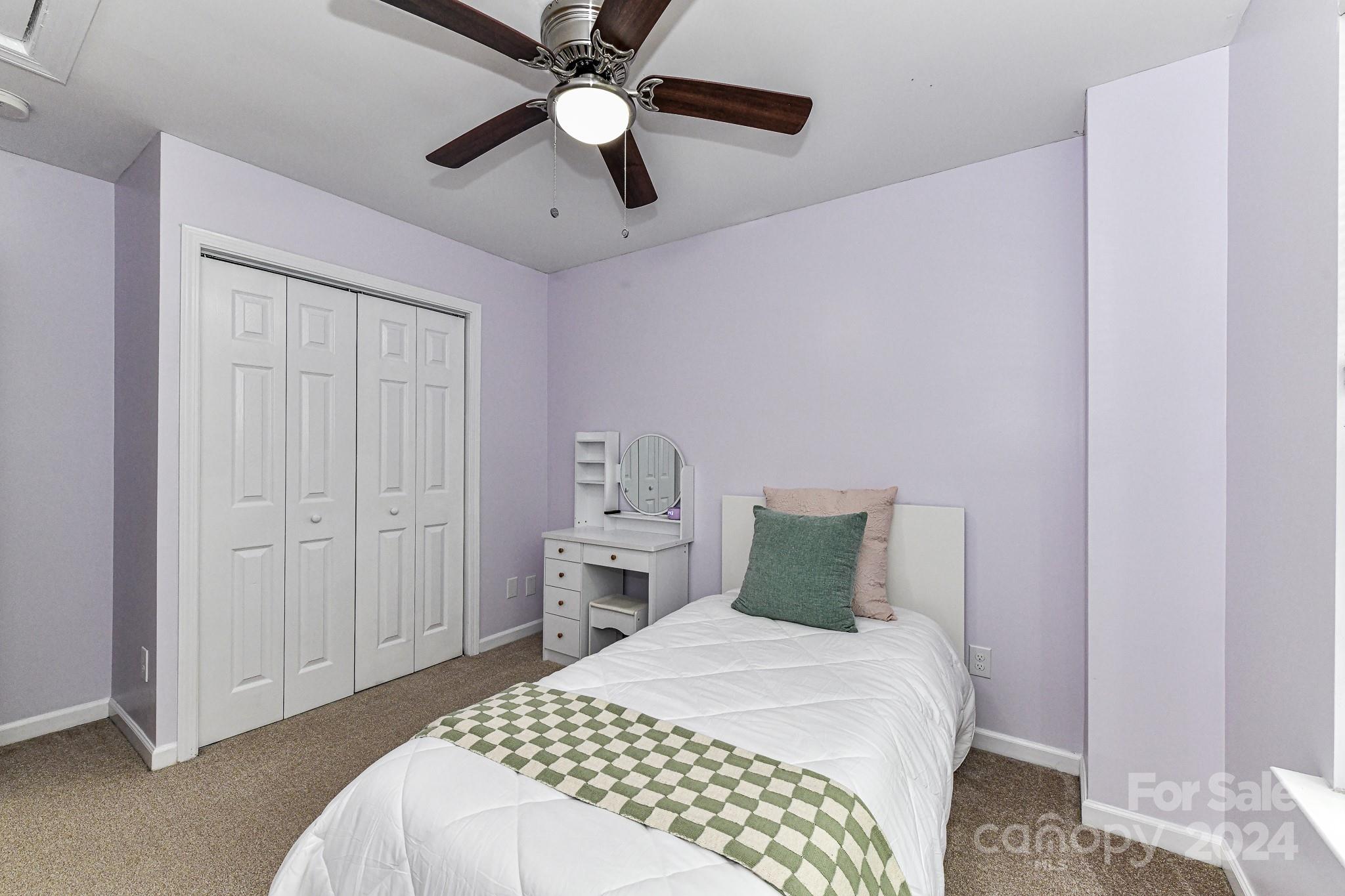 9665 Bailey Road Cornelius, NC 28031 - Photo 21 of 31 a bedroom with a bed and a chandelier