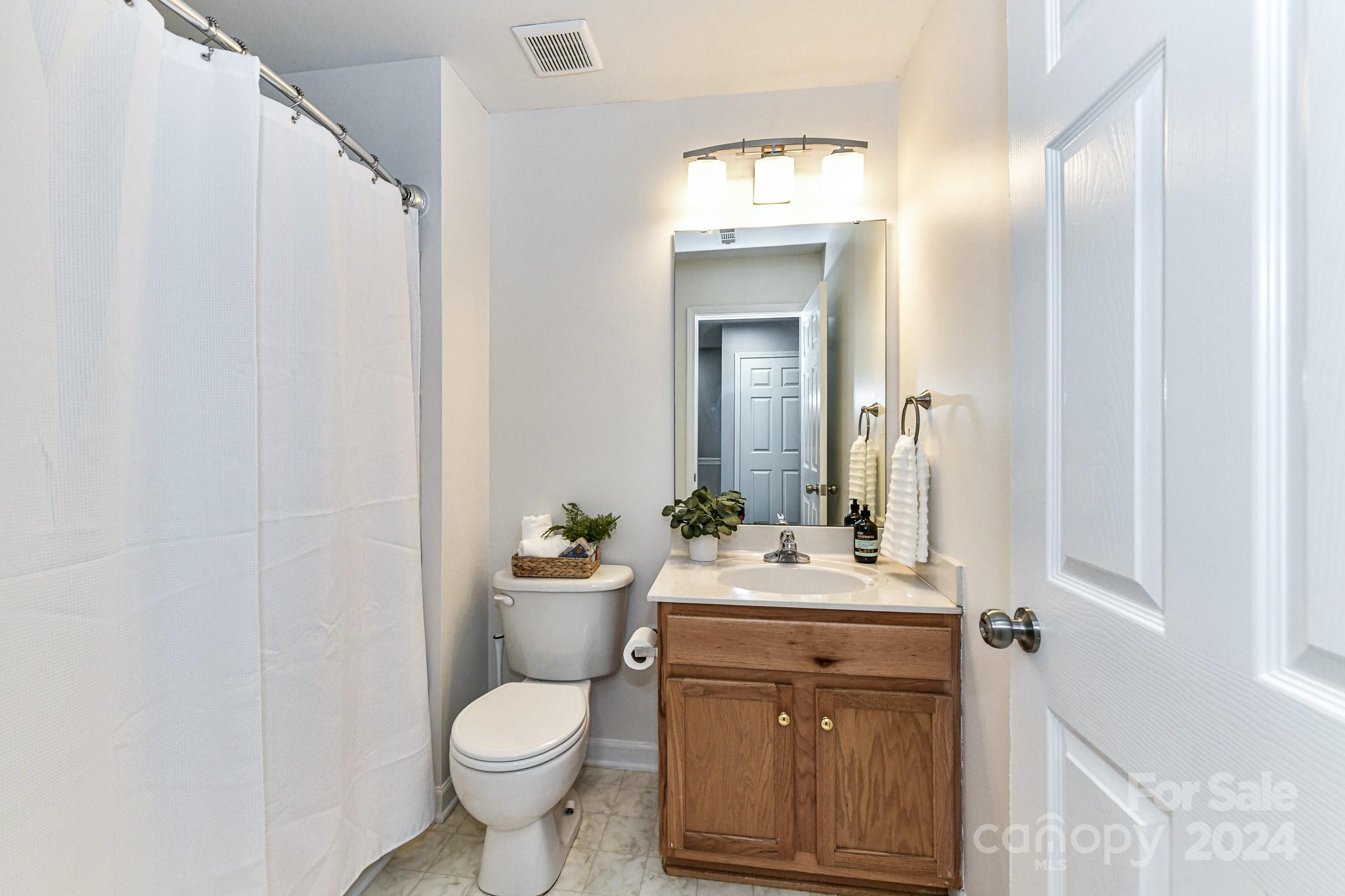 9665 Bailey Road Cornelius, NC 28031 - Photo 22 of 31 a bathroom with a toilet sink and mirror