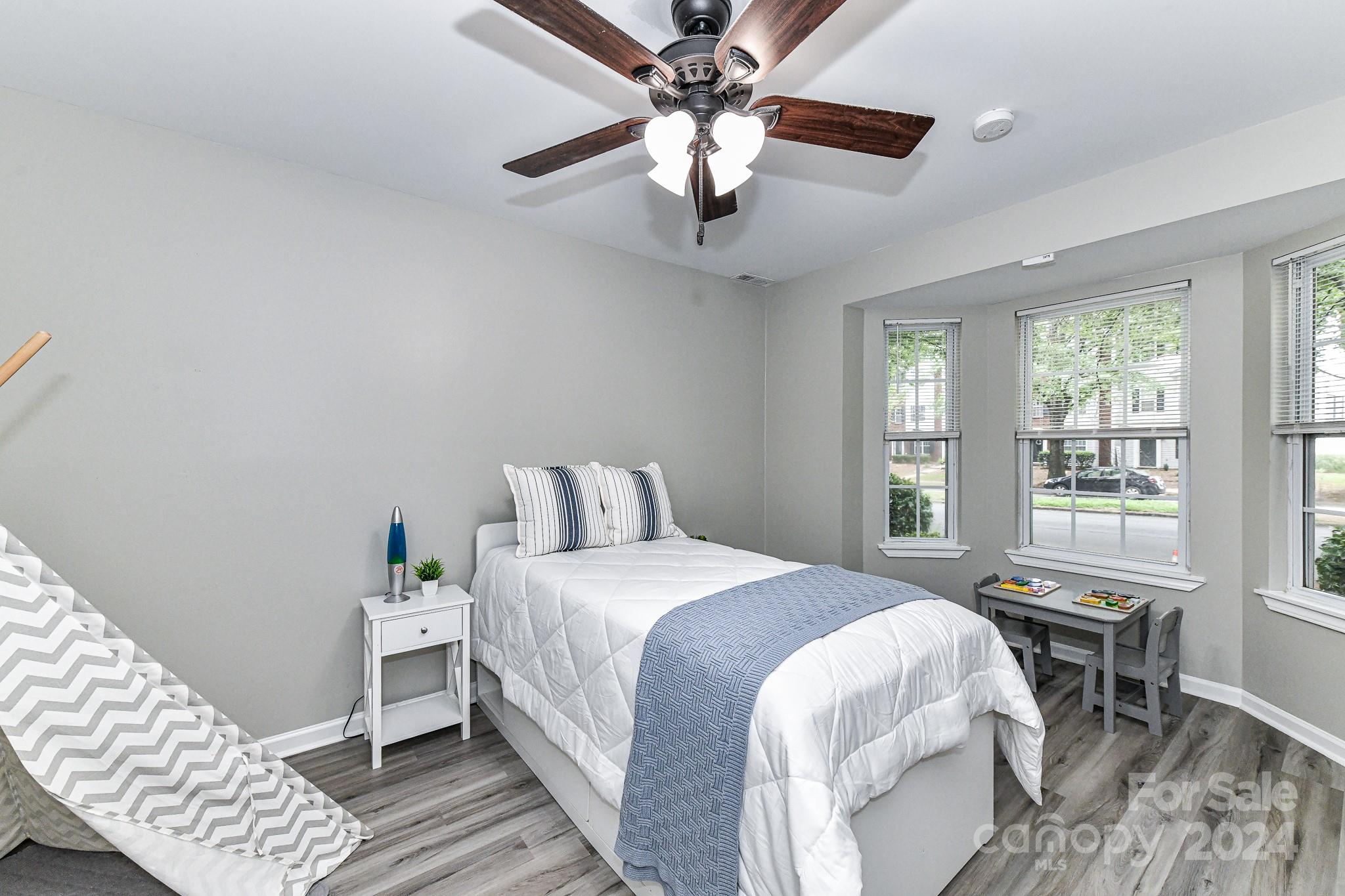 9665 Bailey Road Cornelius, NC 28031 - Photo 4 of 31 a bedroom with a bed and a chandelier