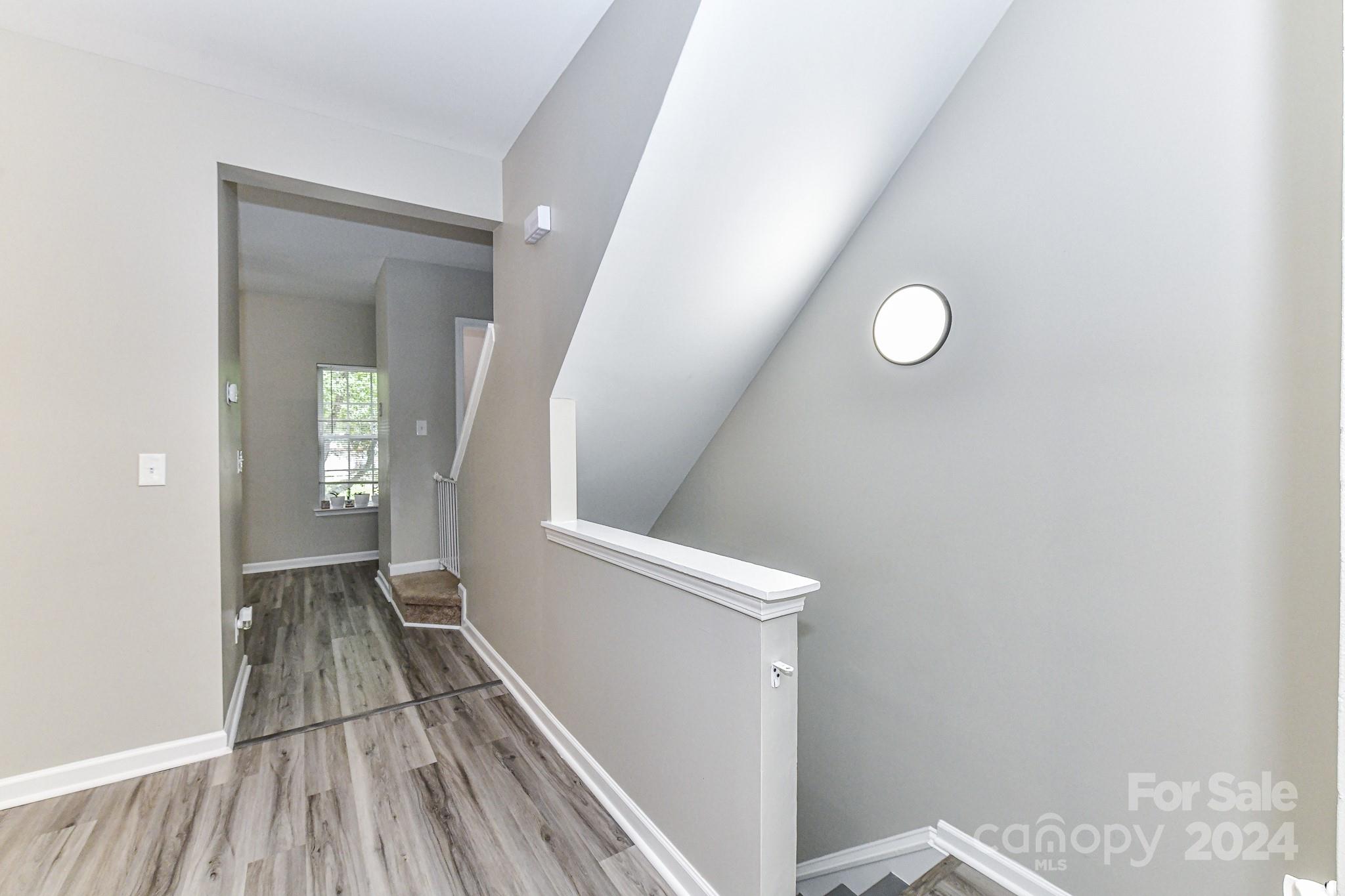 9665 Bailey Road Cornelius, NC 28031 - Photo 7 of 31 a view of a hallway with wooden floor