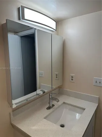 a bathroom with a light fixture and a glass shower