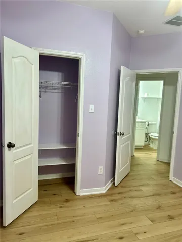 a view of a room with wooden floor and closet