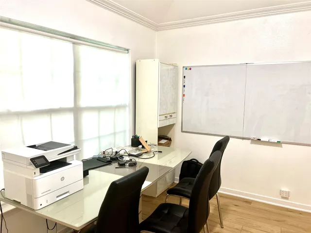 a view of a dining room with furniture and a window