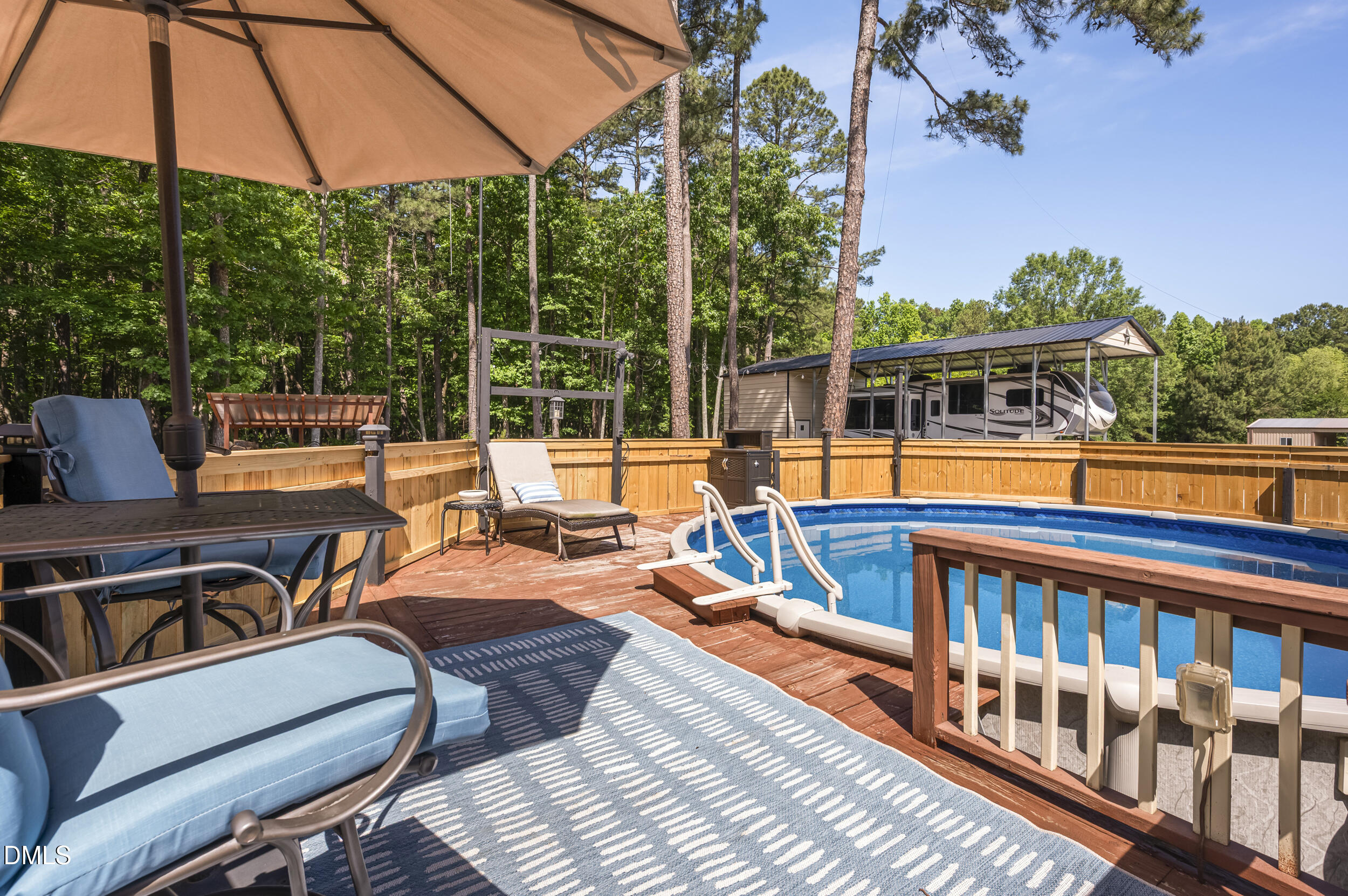 4209 Lassiter Road Wake Forest, NC 27587 - Photo 9 of 39 a view of a balcony with chairs and wooden floor