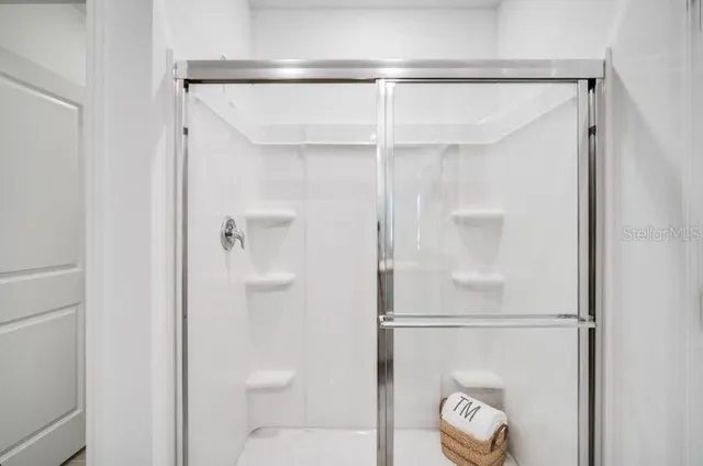 a bathroom with a granite countertop sink and mirror