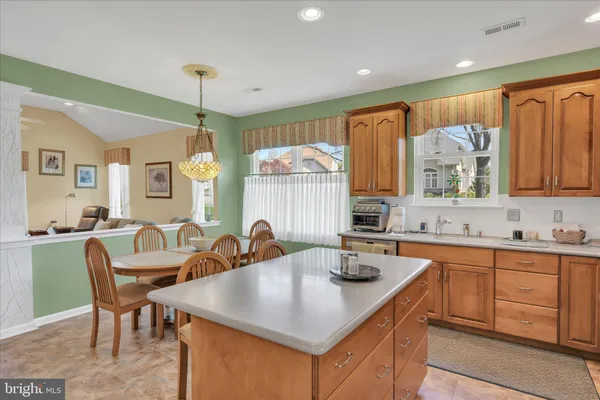 a kitchen with granite countertop a sink and cabinets