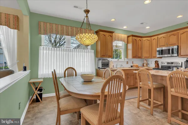 a dining room with furniture a chandelier and window