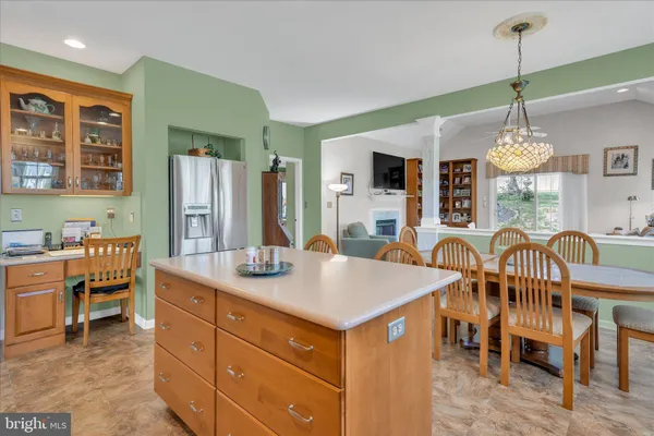a view of a kitchen counter space dining table and chairs