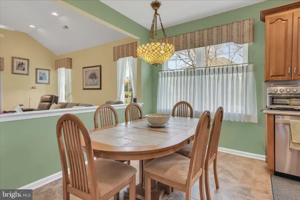 a view of a dining room with furniture and window
