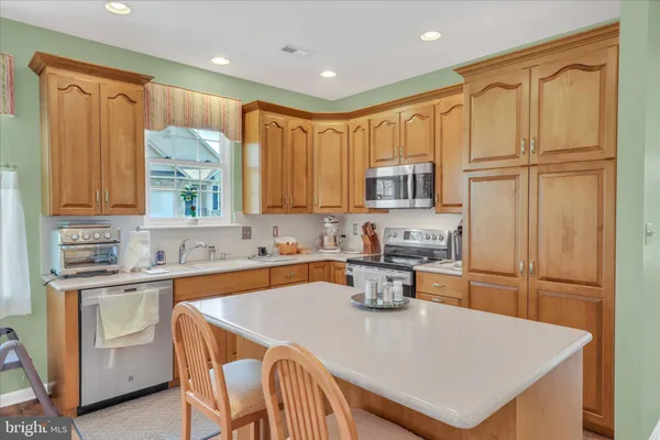 a kitchen with a refrigerator a stove a sink and a cabinets