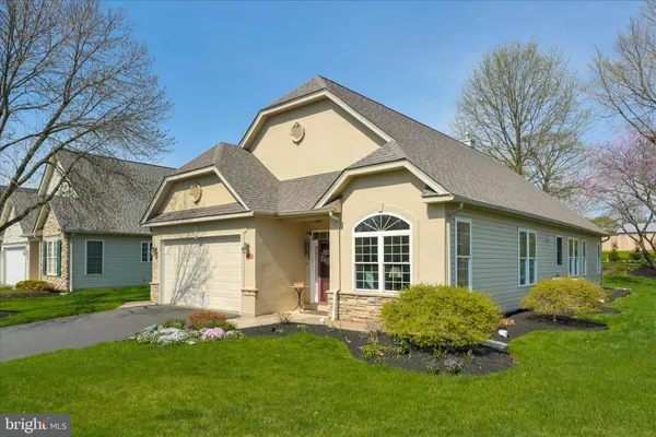 a front view of a house with a yard and porch