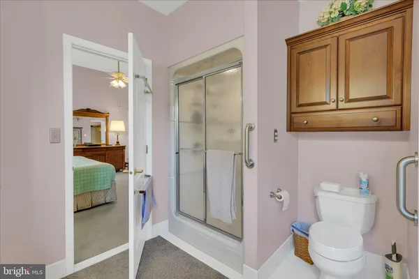 a bathroom with a granite countertop shower mirror and toilet