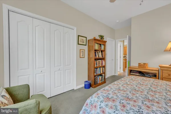 a bedroom with furniture and a book shelf