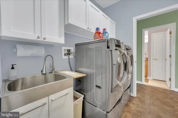 a utility room with cabinets and a sink