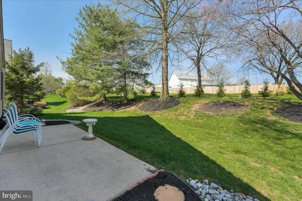a garden with trees in the background