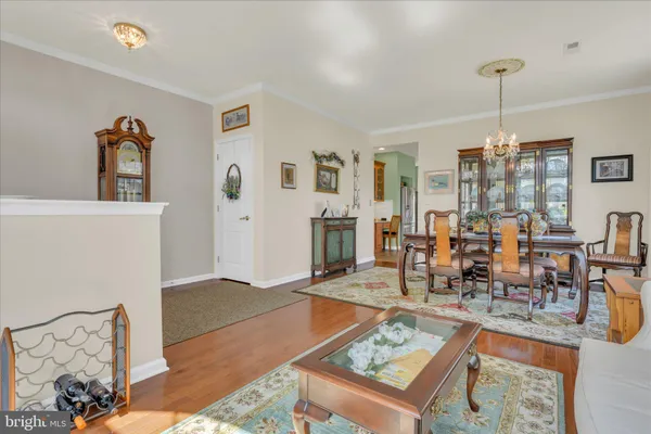 a living room with furniture a dining table and a fireplace