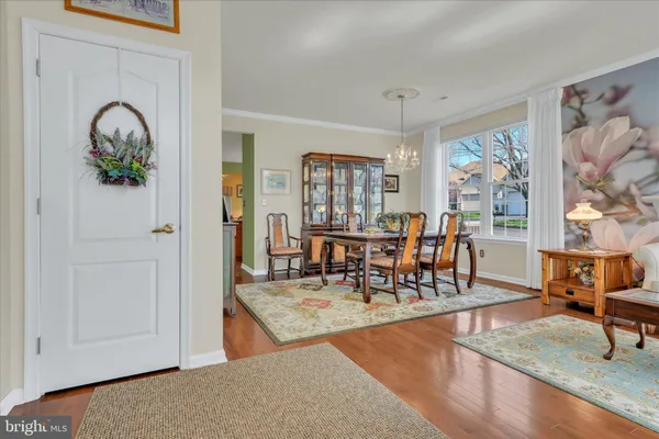 wooden floor view with dining table and chairs