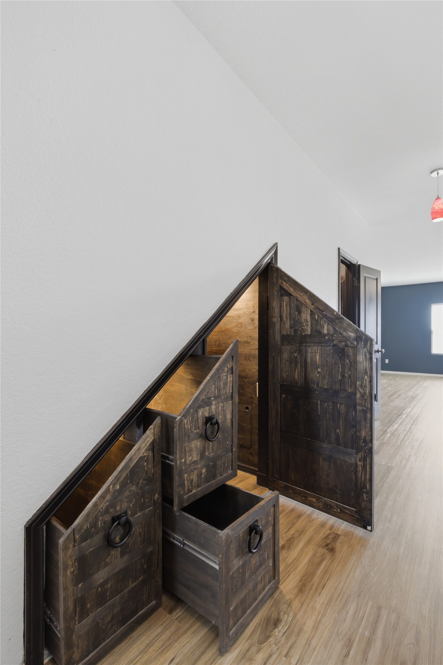 116 Night Riders Way Jarrell, TX 76537 - Photo 7 of 40 Custom under-stair storage with rustic wood-finish panels and dark metal ring pulls