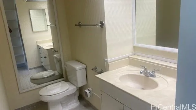 a bathroom with a sink toilet and a mirror