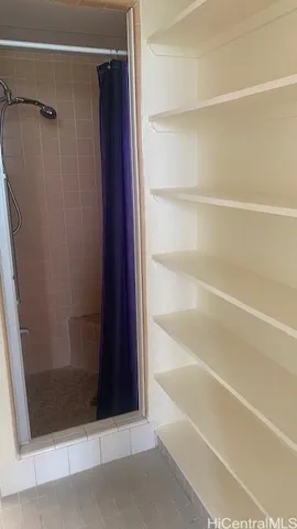 a bathroom with a glass shower door