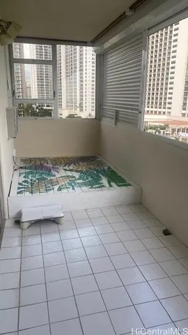 a view of a room that has a window and furniture